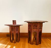 Two lacquered octagonal folding tables with cylinder box on smaller table