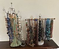 Two jewellery stands fully loaded with assorted beaded necklaces