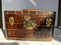 Front view showing faux crocodile pattern, Dresner badge, gold-tone latch hardware