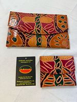 Front view of both wallets and authenticity card