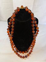 Full view of necklace doubled on bust showing bead color and length
