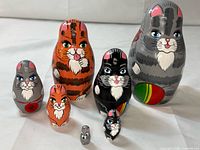 Full view of all seven cat nesting dolls arranged by size