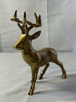 full view of gold-tone reindeer figurine standing