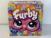 Front of sealed Furby tie-dye retail box