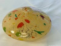 Top view showing fill opening and mottled multicolour design