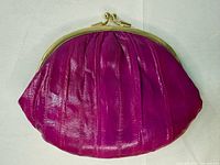 Front view showing pleated pink leather and gold kiss-lock frame