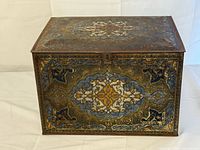 Front view of vintage Heinz 57 biscuit tin showing ornate design and clasp