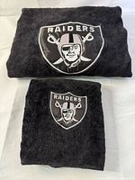Both towels folded showing Raiders logos