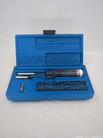 Case open showing handle, extensions, adapter and bits