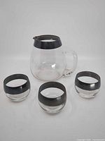 Pitcher and three glasses front view