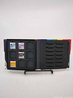 Open storage case showing foam insert and four DS cartridges