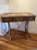 Front view of vanity table closed showing painted surface and legs