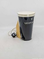 Full view of Guinness bar topper light with cord and plug