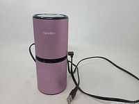 Full view of pink Lapurifier air purifier with USB cable attached