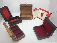 All five boxes open showing red velvet interiors and inserts
