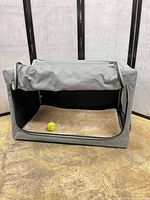 Front view of gray PETSFiT soft crate with mesh door open, showing interior and pad