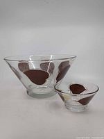 Large and small matching glass bowls showing design
