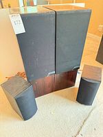 All four speakers: pair of Mission 765 towers behind pair of Atlantic Technology 251.1 LR bookshelf speakers