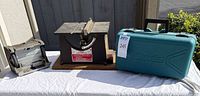 Three power tools: bench grinder, tabletop saw, Makita case