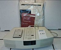 Front view of Bose Wave Radio with remote and documentation