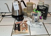 Overview of kettle, moka pot, mugs, gaskets, box and booklet