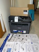 Front view of printer with toner box and setup guide