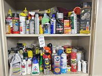 Full cabinet view showing quantity and variety of aerosol cans, bottles and boxes