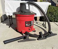 Shop vac with hose and floor nozzle attached