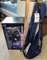 Boxed Meade ETX-90EC telescope beside blue Meade tripod bag and yardstick for scale