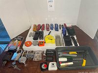 Full lot overview showing knives, padlocks, tape measures, hand tools