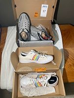Both pairs of sneakers in original boxes showing overall condition and style
