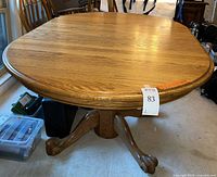 Full view of oak pedestal dining table showing top and base