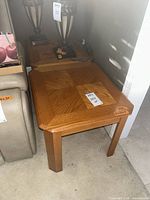 Full view of first oak end table next to sofa