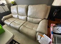 Front angled view of beige leather Simon Li sofa