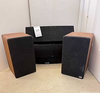 Two wood-veneer bookshelf speaker, two black center speakers