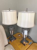 Front view of both bronze finish lamps with shades