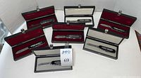 Seven boxed Victorinox Battle Series knives displayed together