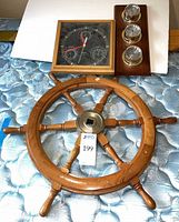 Overall view of ship wheel, Sunbeam clock, Fischer weather panel