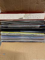 Box showing stacked records and laser discs, Pops Varieties spine visible