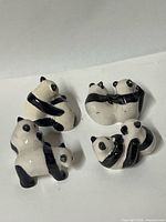 All four panda pair figurines grouped