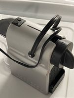 Full view of DeLonghi Nespresso machine right side and front