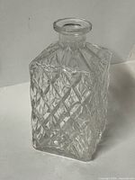 front view of square diamond-pattern glass decanter