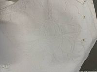 Close-up of hand embroidered floral motif on tablecloth