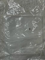 Folded white tablecloth and napkins in plastic wrapping