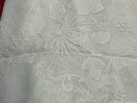 Close-up of white cotton tablecloth embroidery