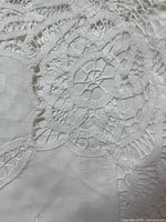 Close-up of cutwork and embroidery on tablecloth