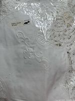 Tablecloth in plastic showing size label and embroidery