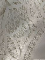 Close-up of white cotton hand-embroidered cutwork