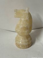 front left view of carved stone knight on plinth