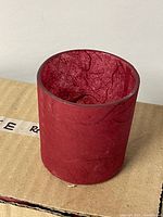 single red paper maché votive holder on box